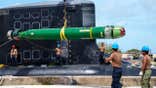 Sailors load a torpedo