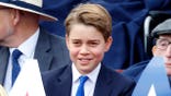 Prince George of Wales attends a military procession on The Mall in London.