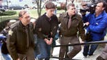 Robert Tulloch being led into court by sheriff deputies.