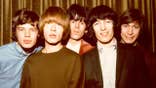 The Rolling Stones posing for a photo together in 1964.
