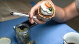 Woman holding joint and carrot cake at cafe