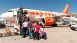 Passengers outside EasyJet plane