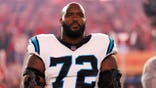 Taylor Moton stands on the sidelines