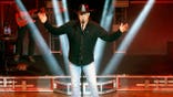Trace Adkins gestures to the crowd