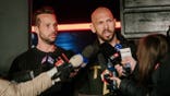 Andrew Tate talks to the media outside his residence in Bucharest, Romania.