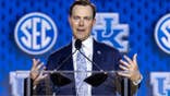 Will Stein speaks at a podium at SEC Football Media Day in Tampa, Florida.