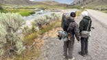 Two fishermen standing outside Yellowstone river