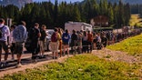 Tourists queue to take the shuttle bus to the Tre Cime di Lavaredo
