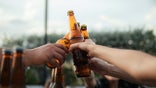 Friends toast with beer