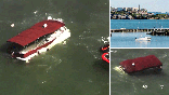 A pontoon boat burns near Alcatraz Island off the coast of San Francisco on Tuesday after catching fire, prompting a rescue operation in which 17 people were pulled from the water while one person remained missing, authorities said.