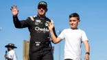 Kyle Busch stands with son Brexton Busch at Phoenix Raceway.
