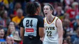 Caitlin Clark gestures toward a referee during a game at Gainbridge Fieldhouse.