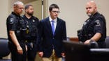 Colt Gray is led by deputies into court.