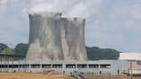Cooling towers of Susquehanna Steam Electric Station rise beyond an AWS data center construction project.