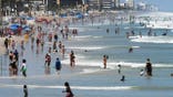 People enjoy swimming and surfing at Daytona Beach on Labor Day.