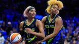 DiJonai Carrington is held by NaLyssa Smith during a WNBA game in Arlington, Texas.