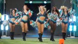Miami Dolphins cheerleaders dance for fans at Hard Rock Stadium.