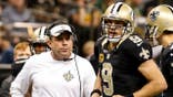 Sean Payton and Drew Brees talk during the second quarter of a Saints game.