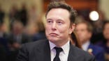 Elon Musk listens as Donald Trump speaks at a House Republicans Conference meeting.