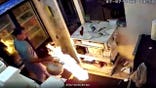 Man carrying flaming propane tank inside restaurant