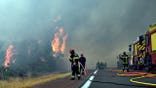 Firefighters spray water at a burning forest near Lacanau, France.