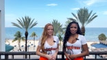 Hooters girls Gracie Williams and Micayla Williams pose for a photograph with the Atlantic Ocean in the background.