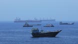 A view of commercial cargo vessels and crude oil tankers are anchored in the Gulf of Oman, off the coast of Muscat, Oman, on June 21, 2026, as they prepare to transit through the critical Strait of Hormuz. Maritime traffic along this vital global trade corridor experienced severe disruptions following heightened geopolitical tensions between the United States and Iran that escalated earlier in February. Following a diplomatic memorandum of understanding reached in mid-June, the strategic waterway is expected to fully reopen to international shipping and energy transit.