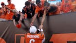 Jake Browning shakes hands with fans after the NFL game.