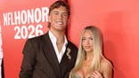 Jaxson Dart and Marissa Ayers stand at the NFL Honors event.
