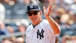 Joe Girardi salutes the crowd at Yankee Stadium.