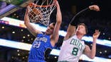 Jonas Jerebko of the Boston Celtics defends Mario Hezonja of the Orlando Magic during an NBA game.