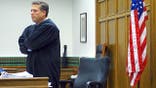 Judge Roger Rogoff stands in court in Seattle
