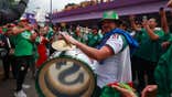 Mexico soccer fans celebrating at a World Cup match amid reports of seismic activity triggered by crowd noise.