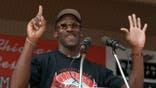 Michael Jordan holds up six fingers while addressing a crowd at Grant Park in Chicago.