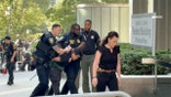 Authorities apprehend someone outside of a federal building in New York City