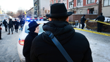 Hasidic Jewish community gather outside of the Chabad Lubavitch HQ