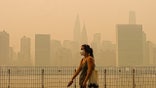 Woman in mask in NYC amid wildfire smoke