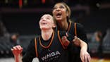 Paige Bueckers and Angel Reese react during WNBA All-Star practice at Gainbridge Fieldhouse.