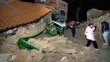 Residents walk amid debris in Pumpuya, Peru.