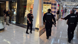 Law enforcement officers move through Deerbrook Mall in Humble, Texas, as they respond to a reported shooting.