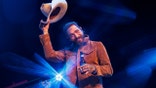 post malone tips hat on stage.