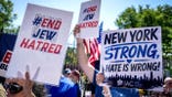 Pro-Israeli protesters hold signs at a rally opposing New York City Mayor Zohran Mamdani.
