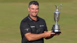 Ryan Fox of New Zealand holds The Claret Jug