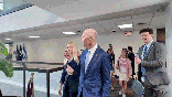 GIF of Rick Scott being followed by protestors