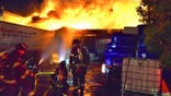 Firefighters in front of a fire