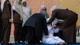 woman falls near group of other women