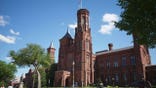 People walk on the National Mall near the Smithsonian Castle in Washington, D.C.