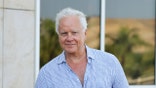 Tim Robbins speaks during a press conference at the Magna Graecia Film Festival in an indoor venue.