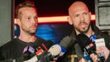 Andrew Tate and Tristan Tate talk to the media outside their residence in Bucharest, Romania.