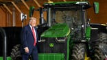 Trump walking by tractor at farmer event